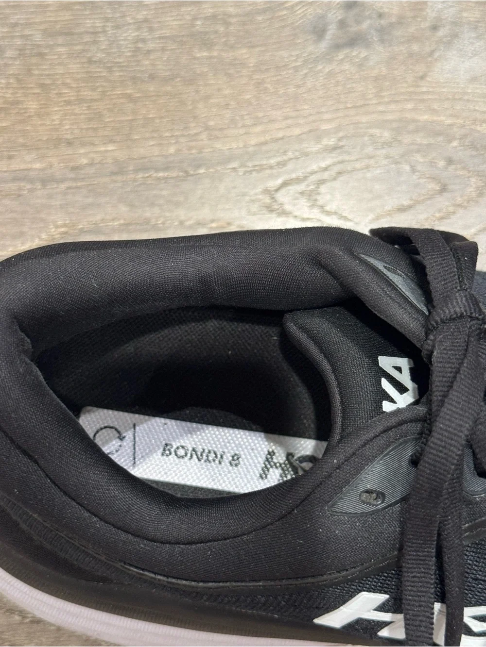 Hoka One One Bondi 8 running shoes feature a black upper and a white midsole